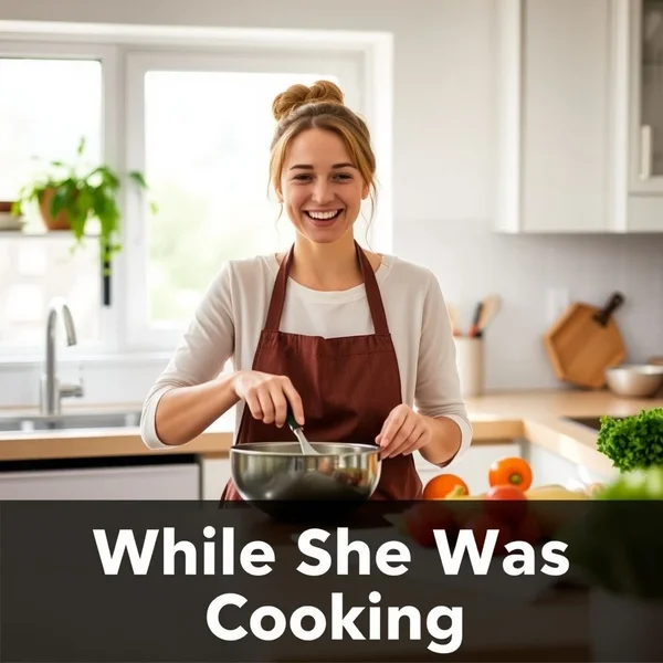 Afbeelding: Een vrouw die blij aan het koken is in een keuken while she was cooking.