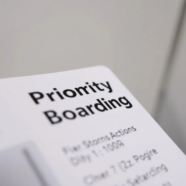 An airline gate showing a sign for priority boarding