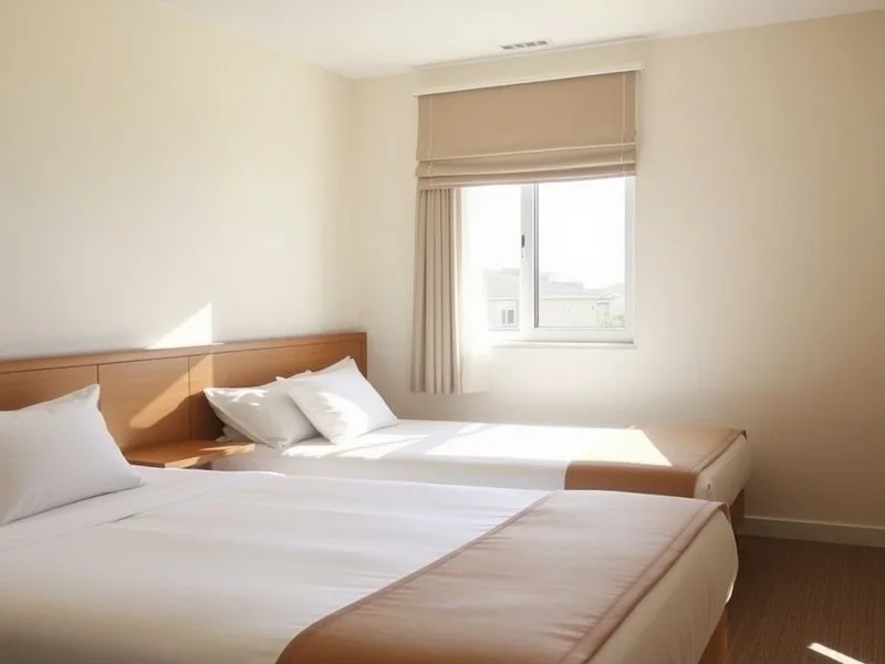 Two single beds inside a hotel room, which is the definition of a twin room