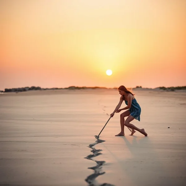 Woman drawing a line in the sand to illustrate how to Draw The Line idiomatically
