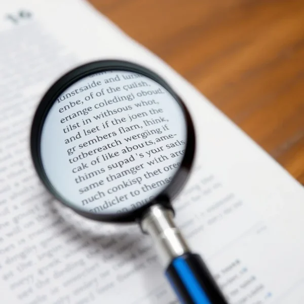 A magnifying glass checking over a document, illustrating the phrasal verb "check over".